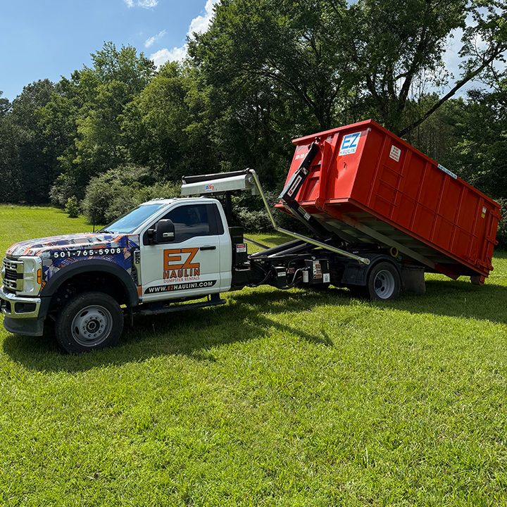 Roll-off dumpster set in a residential driveway in Alexander, AR by EZ Haulin